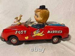 Vintage Japanese Tin Battery Operated Kissing Couple Car by Ichida Toys W-78
