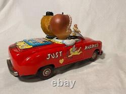 Vintage Japanese Tin Battery Operated Kissing Couple Car by Ichida Toys W-78