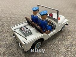 + Vintage Nomura Japan Tin Battery Operated Police Jeep with Firing Gun